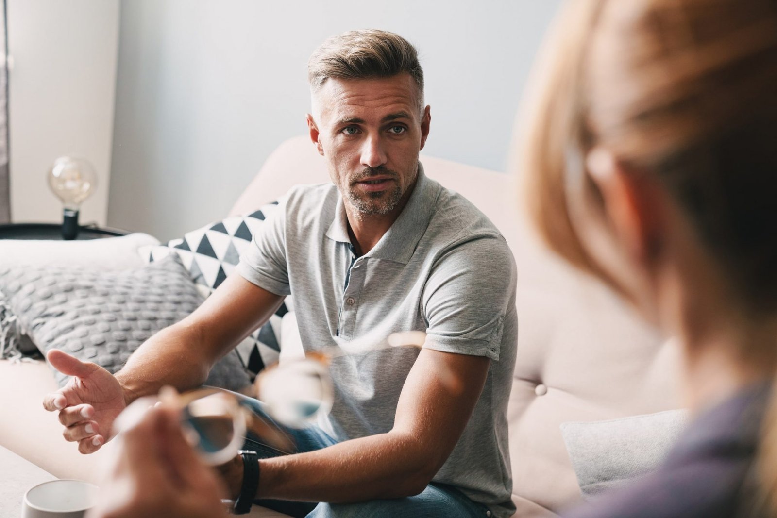 Photo Of Brooding Handsome Man Having Conversation With Psychologist In